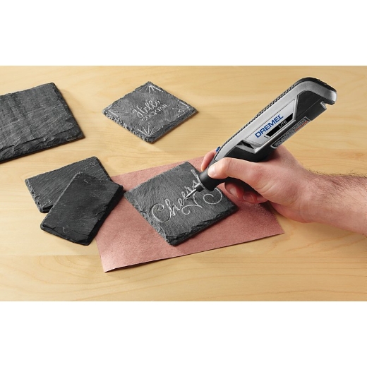 Una persona que usa Dremel 7760 lite para grabar posavasos de piedra